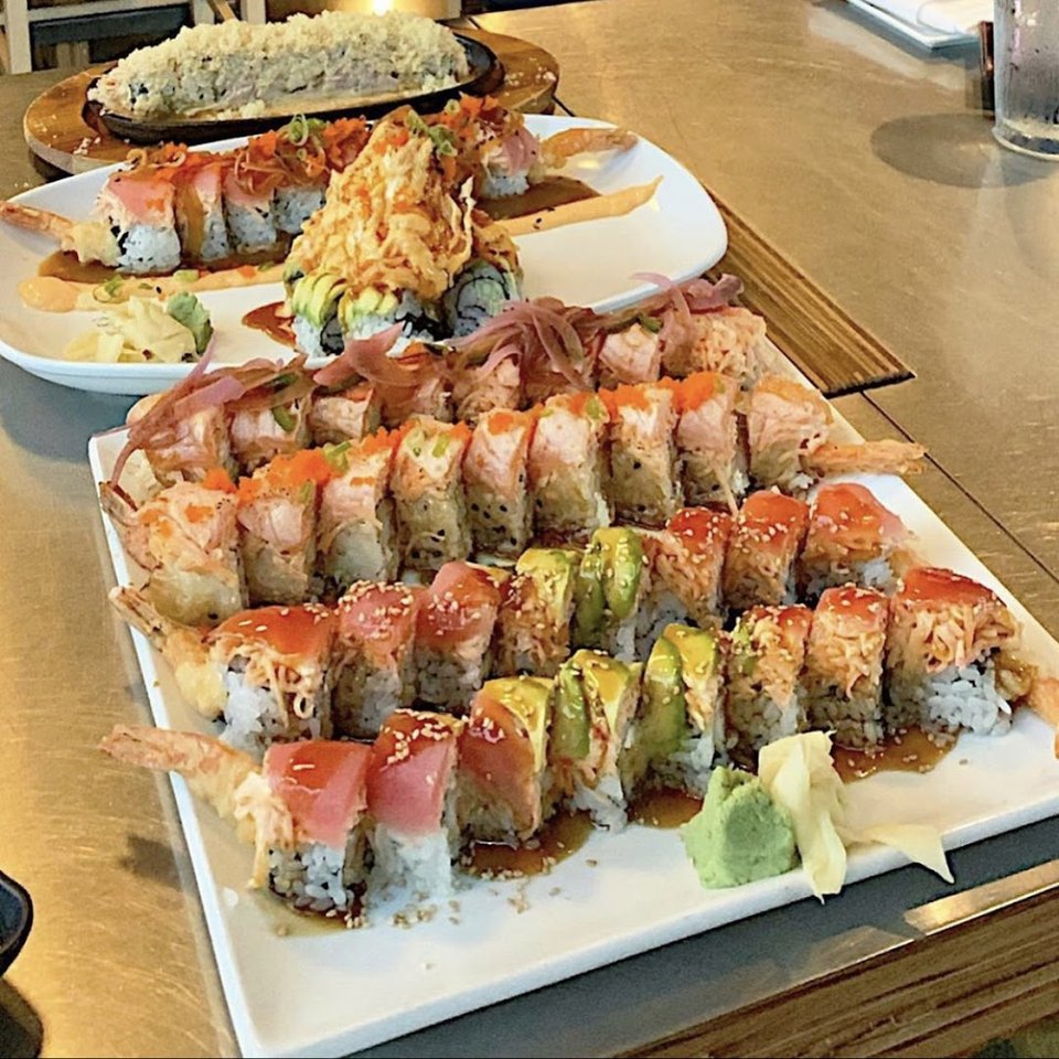 A bright sushi counter with fusion-style dishes.